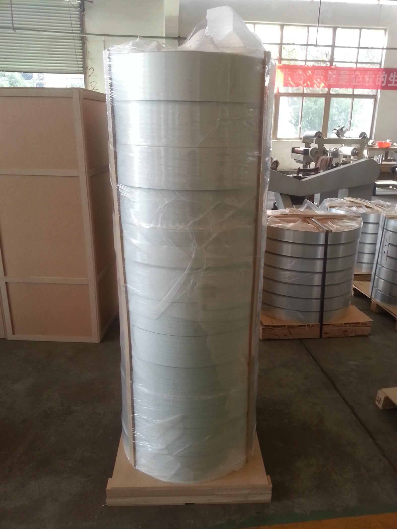 Packaged coils of polymer-coated aluminium material in the workshop